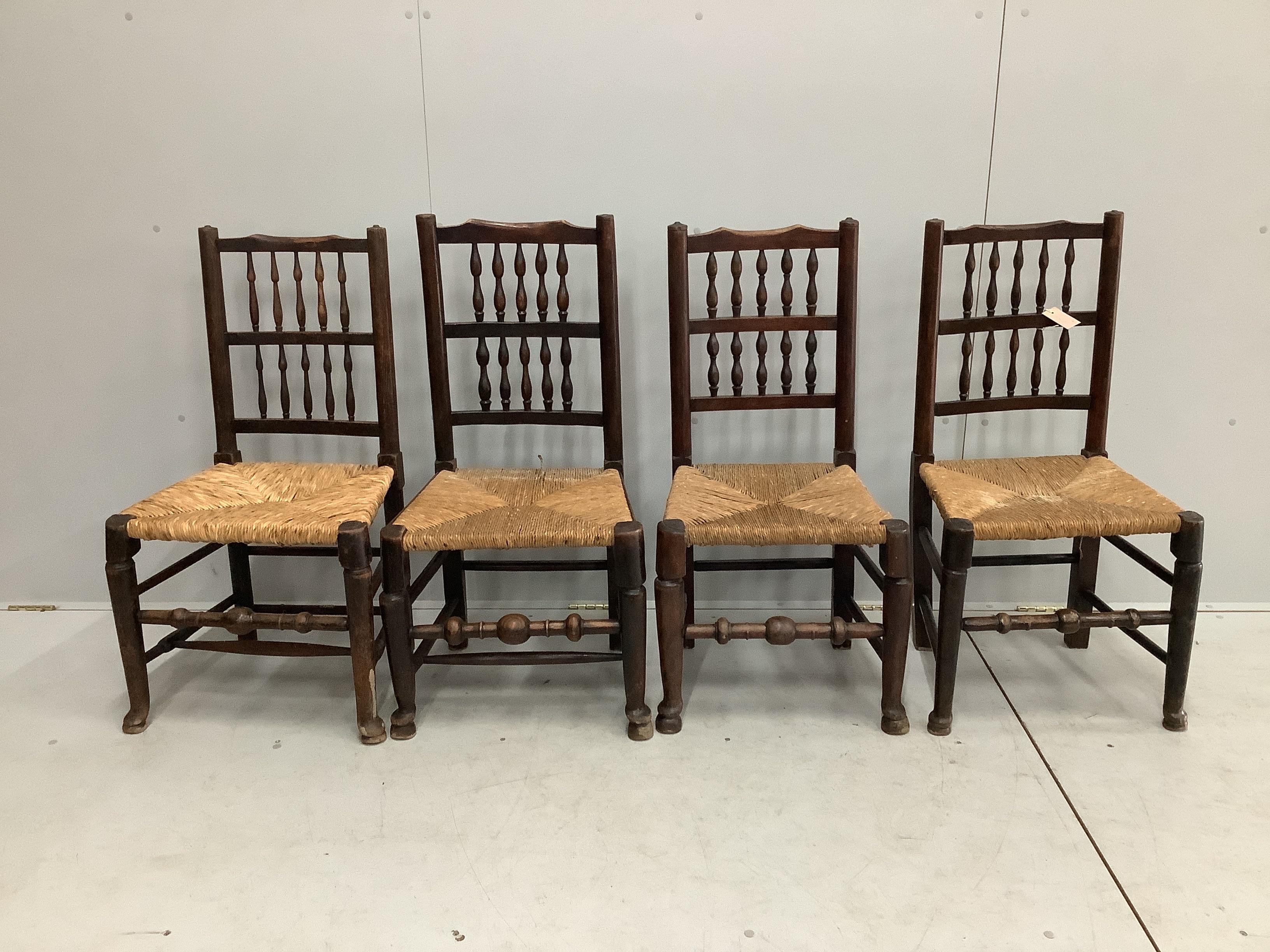 A harlequin set of four Lancashire rush seat spindle back dining chairs